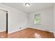 Bright bedroom with hardwood floors, light walls, and a window for natural light at 1020 N Ritter Ave, Indianapolis, IN 46219