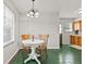 Cozy dining area features a round table, vintage chairs, and a chandelier, perfect for intimate meals at 1020 N Ritter Ave, Indianapolis, IN 46219