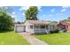 Charming home with a front porch, well-maintained lawn, and attached garage at 1020 N Ritter Ave, Indianapolis, IN 46219