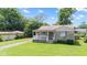 Charming home with a front porch, well-maintained lawn, and attached garage at 1020 N Ritter Ave, Indianapolis, IN 46219