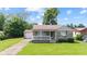 Charming home with a front porch, well-maintained lawn, and attached garage at 1020 N Ritter Ave, Indianapolis, IN 46219
