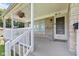 Inviting front porch adorned with hanging flower baskets, offering a warm welcome at 1020 N Ritter Ave, Indianapolis, IN 46219