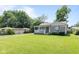 Landscaped front yard of a cozy home, featuring mature trees and a well-maintained lawn at 1020 N Ritter Ave, Indianapolis, IN 46219