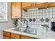 Well-maintained kitchen boasts updated sink fixtures and a bright, inviting atmosphere at 1020 N Ritter Ave, Indianapolis, IN 46219