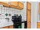Functional kitchen features well-maintained appliances and ample storage space in natural wood cabinets at 1020 N Ritter Ave, Indianapolis, IN 46219
