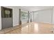 Bright and airy living room with large windows, laminate flooring, and neutral decor at 1020 N Ritter Ave, Indianapolis, IN 46219