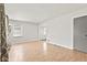 Open living area with laminate floors, freshly painted walls, and natural light at 1020 N Ritter Ave, Indianapolis, IN 46219