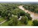 Stunning aerial view of a property nestled amidst lush greenery and a river, offering privacy and tranquility at 1065 E 76Th St, Indianapolis, IN 46240