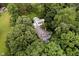 Drone shot showcasing this serene home surrounded by lush greenery, nestled along the edge of a river at 1065 E 76Th St, Indianapolis, IN 46240