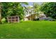 Expansive backyard featuring lush green lawn and a chicken coop at 1065 E 76Th St, Indianapolis, IN 46240