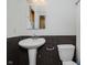 Bathroom with black and white tiling, pedestal sink, and toilet at 1065 E 76Th St, Indianapolis, IN 46240