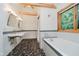 Modern bathroom with dual sinks, a soaking tub, mosaic tile accents, and a large window at 1065 E 76Th St, Indianapolis, IN 46240