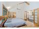 Bright bedroom featuring a vaulted ceiling, unique wood headboard, and an en-suite bathroom at 1065 E 76Th St, Indianapolis, IN 46240
