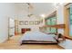 Bright and airy bedroom boasting a vaulted ceiling, unique wood headboard, and ample natural light at 1065 E 76Th St, Indianapolis, IN 46240