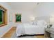 Inviting bedroom featuring white walls, wood-trimmed windows and a luxurious bed with a serene view at 1065 E 76Th St, Indianapolis, IN 46240