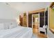 Charming bedroom boasting exposed brick, hardwood floors, a plush bed, and an ensuite bathroom at 1065 E 76Th St, Indianapolis, IN 46240