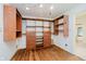 Spacious walk-in closet with custom wood shelving, drawers, track lighting, and hardwood floors at 1065 E 76Th St, Indianapolis, IN 46240