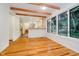 Bright dining area featuring wood beams, hardwood floors, and large windows with a view of the outdoors at 1065 E 76Th St, Indianapolis, IN 46240