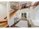 Grand two-story foyer featuring a staircase with wooden treads, a balcony, and double glass front doors at 1065 E 76Th St, Indianapolis, IN 46240