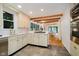 Bright kitchen featuring stainless steel appliances, stone floors, custom cabinetry, and a gas cooktop at 1065 E 76Th St, Indianapolis, IN 46240