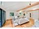 Bright and airy living room with vaulted ceilings, wooden beams, hardwood floors, and large windows at 1065 E 76Th St, Indianapolis, IN 46240
