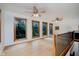 Spacious loft area featuring wood floors, railing, and multiple windows bringing in plenty of natural light at 1065 E 76Th St, Indianapolis, IN 46240