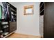 Organized walk-in closet featuring custom shelves, drawers, and ample storage space with a window at 1065 E 76Th St, Indianapolis, IN 46240