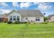 Expansive backyard with lush green grass, complete with a brick patio at 10712 Cardinal Cir, Indianapolis, IN 46231