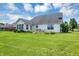 Spacious backyard featuring a well-maintained lawn and a charming brick patio area at 10712 Cardinal Cir, Indianapolis, IN 46231