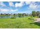 Backyard view of pond, landscaping, and neighboring houses at 10712 Cardinal Cir, Indianapolis, IN 46231
