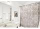 Bathroom showcasing a white patterned shower curtain, toilet, sink, and wall mirror at 10712 Cardinal Cir, Indianapolis, IN 46231