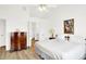 A bedroom featuring a bed with white sheets, a chest of drawers, and an attached bathroom at 10712 Cardinal Cir, Indianapolis, IN 46231