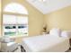 Bedroom featuring a large window with natural light, neutral carpet, and an accent chair at 10712 Cardinal Cir, Indianapolis, IN 46231
