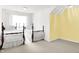 Bedroom features two beds with carpet floors, neutral paint, and a bright window at 10712 Cardinal Cir, Indianapolis, IN 46231