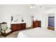 Bedroom with an antique chair, two dressers, an ensuite bath, and a bright window at 10712 Cardinal Cir, Indianapolis, IN 46231