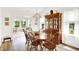 Sunlit dining room featuring a wooden table, matching chairs, and a china cabinet, creating an inviting atmosphere at 10712 Cardinal Cir, Indianapolis, IN 46231