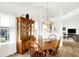 Well-lit dining room with a wooden table, chairs, china cabinet, and views into the adjacent living space at 10712 Cardinal Cir, Indianapolis, IN 46231