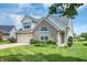 Charming single-Gathering home featuring an attached garage, brick facade and well-manicured lawn at 10712 Cardinal Cir, Indianapolis, IN 46231