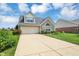 Charming single-Gathering home featuring a brick facade, attached garage, and well-manicured lawn at 10712 Cardinal Cir, Indianapolis, IN 46231