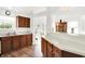 Bright kitchen with wood floors, neutral counters, and a view into an adjacent dining and living space at 10712 Cardinal Cir, Indianapolis, IN 46231