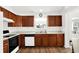 Well-lit kitchen featuring wooden cabinets, modern appliances, and a window view, offering a functional and appealing space at 10712 Cardinal Cir, Indianapolis, IN 46231