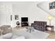Cozy living area featuring high ceilings, neutral walls, and wood flooring at 10712 Cardinal Cir, Indianapolis, IN 46231