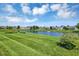 Scenic view of a well maintained pond with a fountain and a neatly manicured lawn at 10712 Cardinal Cir, Indianapolis, IN 46231