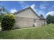 Rear view of a brick home showcasing a well-maintained lawn and back door at 1082 E County Road 400 S, Clayton, IN 46118