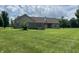 Back exterior of the home showing a fenced deck area with a spacious yard at 1082 E County Road 400 S, Clayton, IN 46118