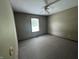 This bedroom offers neutral walls and carpet, with a window to allow natural light and a ceiling fan at 1082 E County Road 400 S, Clayton, IN 46118