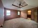 This bedroom features neutral walls and carpet, with two windows to allow natural light and a ceiling fan at 1082 E County Road 400 S, Clayton, IN 46118