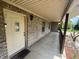 Inviting covered front porch featuring brick accents and a welcoming entrance with a welcome mat at 1082 E County Road 400 S, Clayton, IN 46118