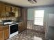 Shows view of kitchen with white range and upper and lower cabinets at 1082 E County Road 400 S, Clayton, IN 46118