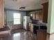 Shows view of kitchen with white refrigerator and black dishwasher and sink at 1082 E County Road 400 S, Clayton, IN 46118
